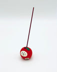 Cat & Apple Incense Stick Holder in use, holding a vertical incense stick at the top of the resin apple.