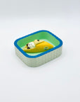 Resin-crafted Cat & Banana incense holder placed inside the mint-green Purrfect Ash Tub for ash catching.