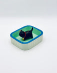 Cat & Bell incense holder placed inside the mint-green Purrfect Ash Tub with a clean minimal aesthetic.