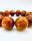 Close-up of Huanghuali Bead Bracelet (large) highlighting the intricate wood grain textures and polished natural finish