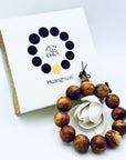 ZA Studio Huanghuali Bead Bracelet (large) displayed with its signature box, showcasing natural grain patterns and warm golden-brown hues.
