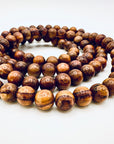 Close-up of Huanghuali Bead Bracelet (small) highlighting the intricate wood grain textures and polished natural finish