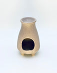 Front view of the Zen Glow Aroma Burner displaying the arched opening and smooth, speckled ceramic finish.
