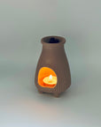 Zen Glow Aroma Burner with a tealight candle inside, showing pellets resting in the top dish.