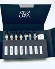 Zen Aroma “Midnight Sampler” open box displaying seven short incense glass vials and a minimalist incense holder, arranged neatly inside black packaging on a white background.