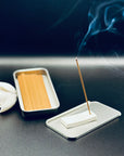 Zen Aroma To-Go Incense Kit in use, with incense stick burning on a minimalist ZA holder and gentle smoke rising against a dark background.