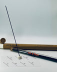 Zen Aroma Ink & Plum incense stick displayed with ceramic holder, glass tube, and brown cardboard tube packaging on a soft white background — minimalist and elegant home fragrance scene.