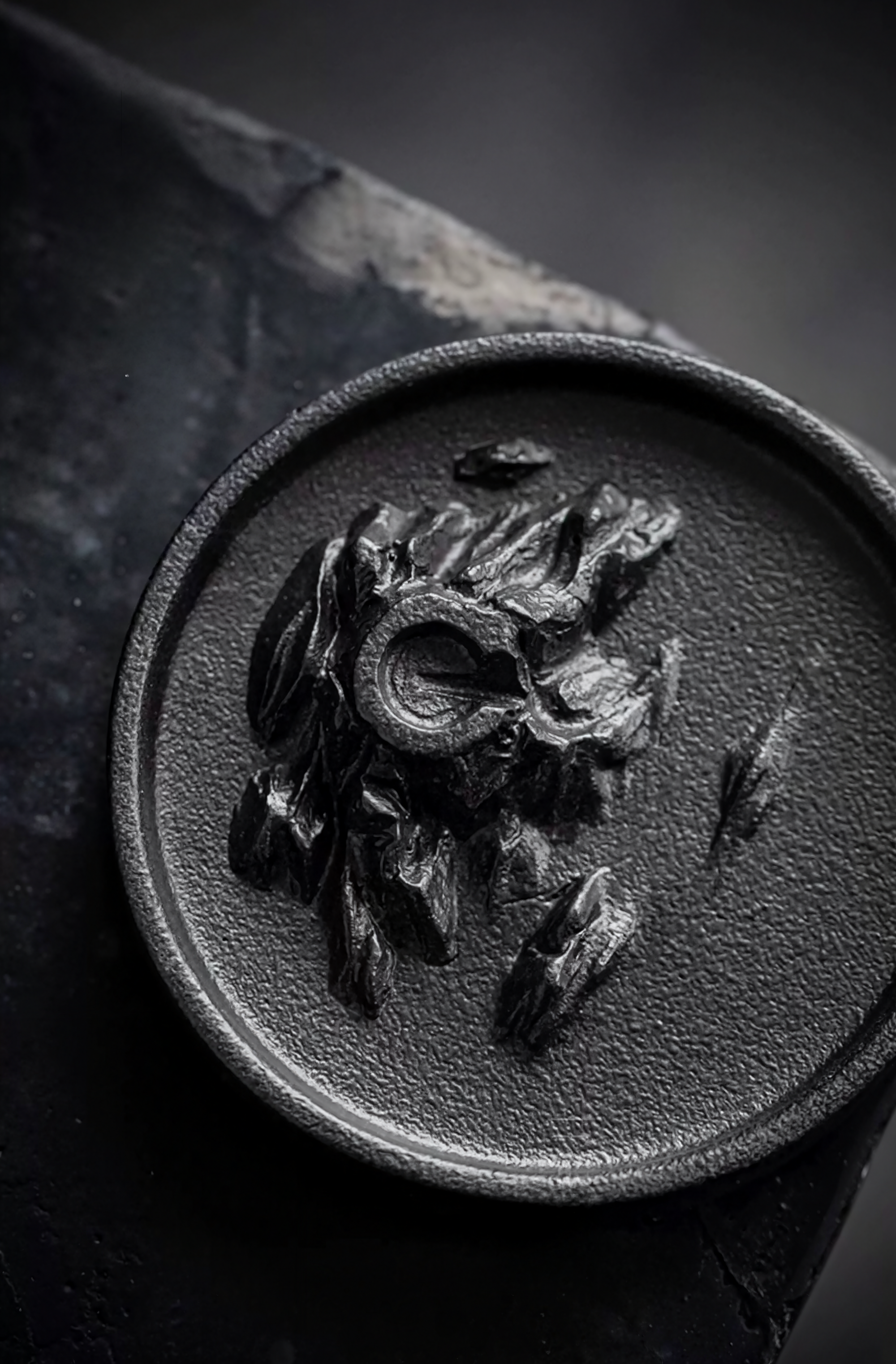 Close-up of a metal object with a detailed design on a dark background