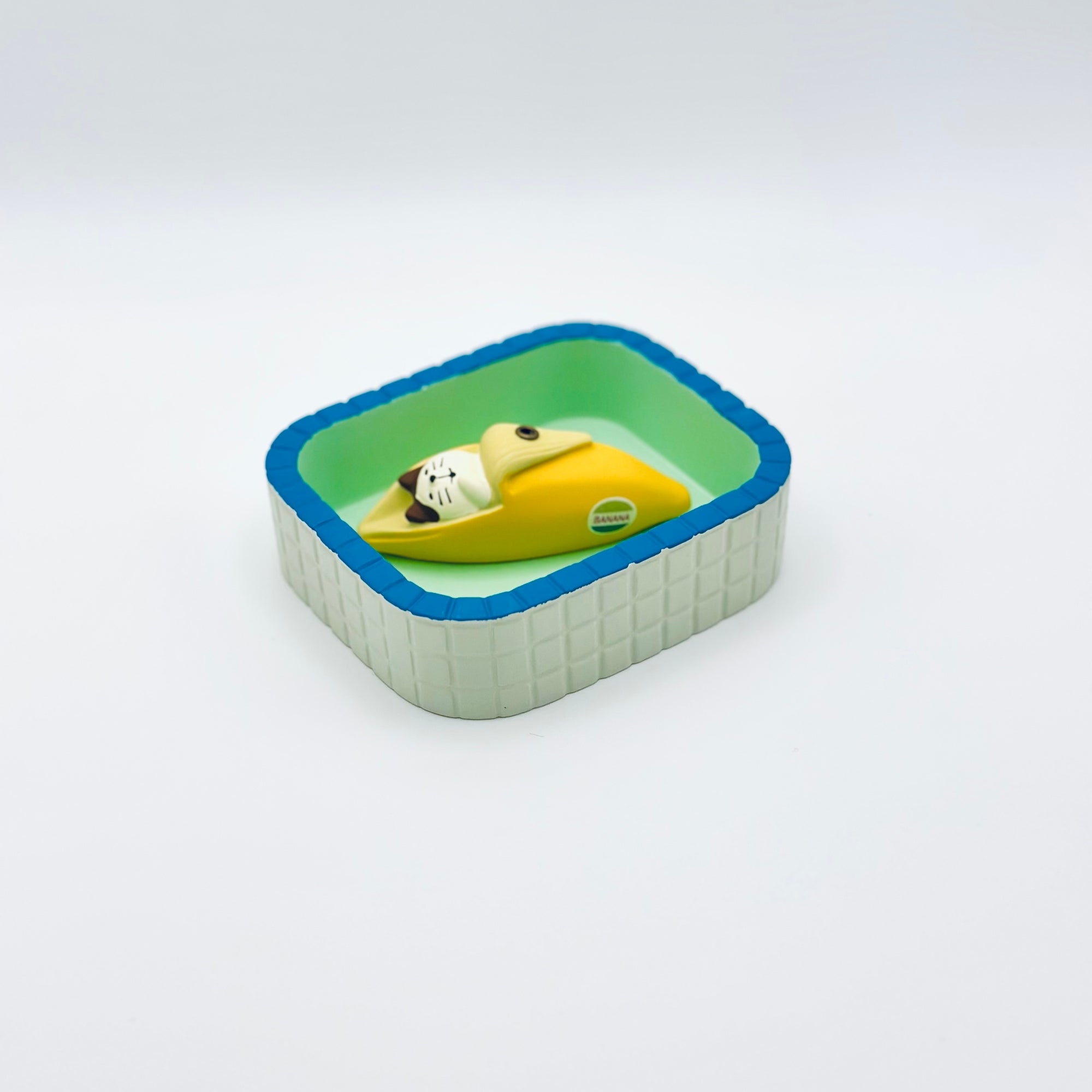Resin-crafted Cat & Banana incense holder placed inside the mint-green Purrfect Ash Tub for ash catching.