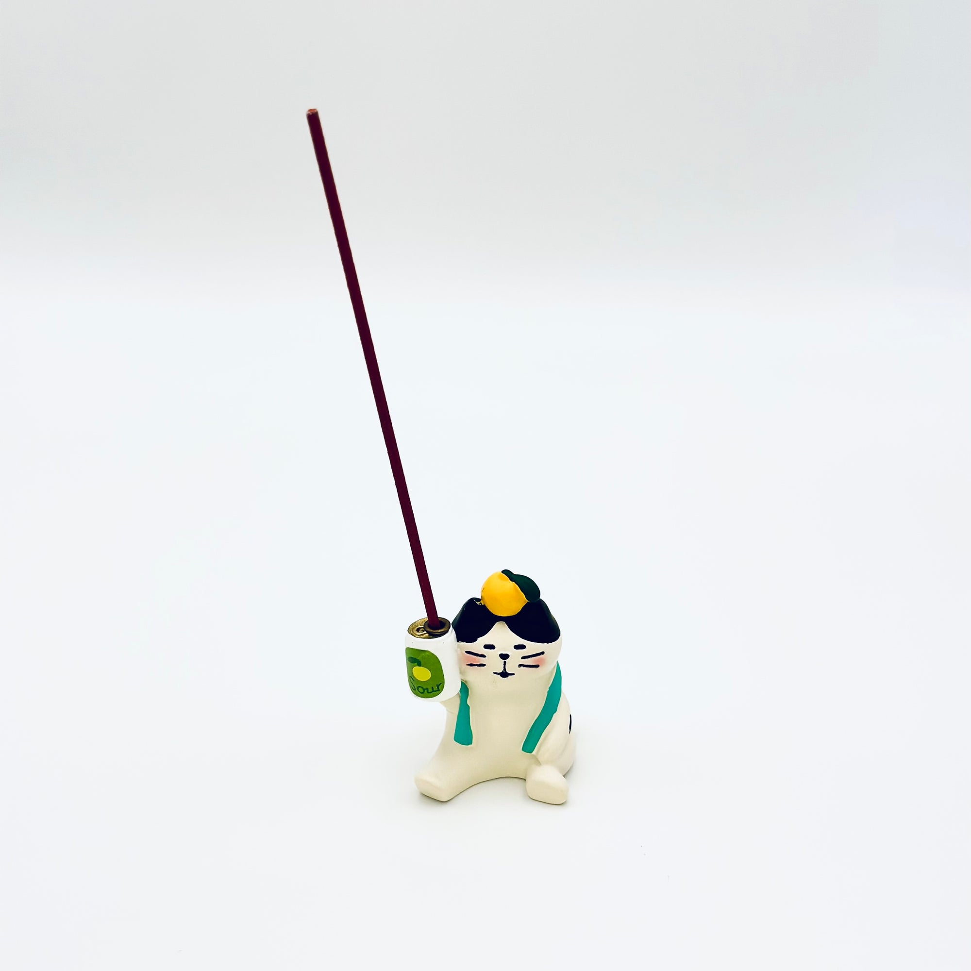 The resin-crafted Cat & Soda Incense Stick Holder in use, holding a vertical incense stick in the soda can opening.
