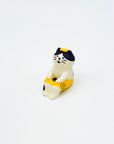 Resin-crafted Cat & Towel Incense Stick Holder shown sitting upright, wearing a yellow towel with a relaxed expression on a clean white background.