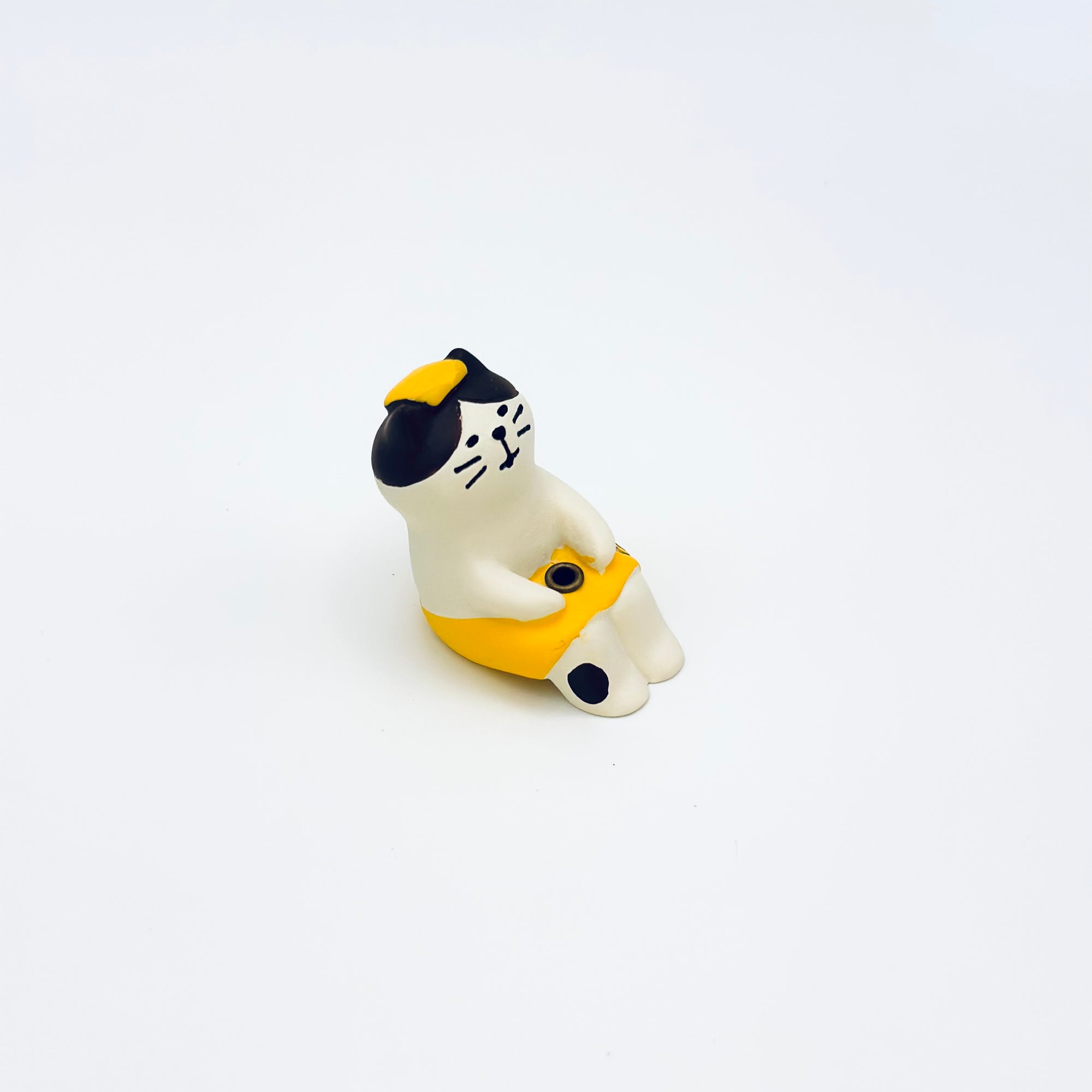 Side view of the resin-crafted Cat & Towel Incense Stick Holder, showing the cat’s yellow towel and small black spot on the leg.