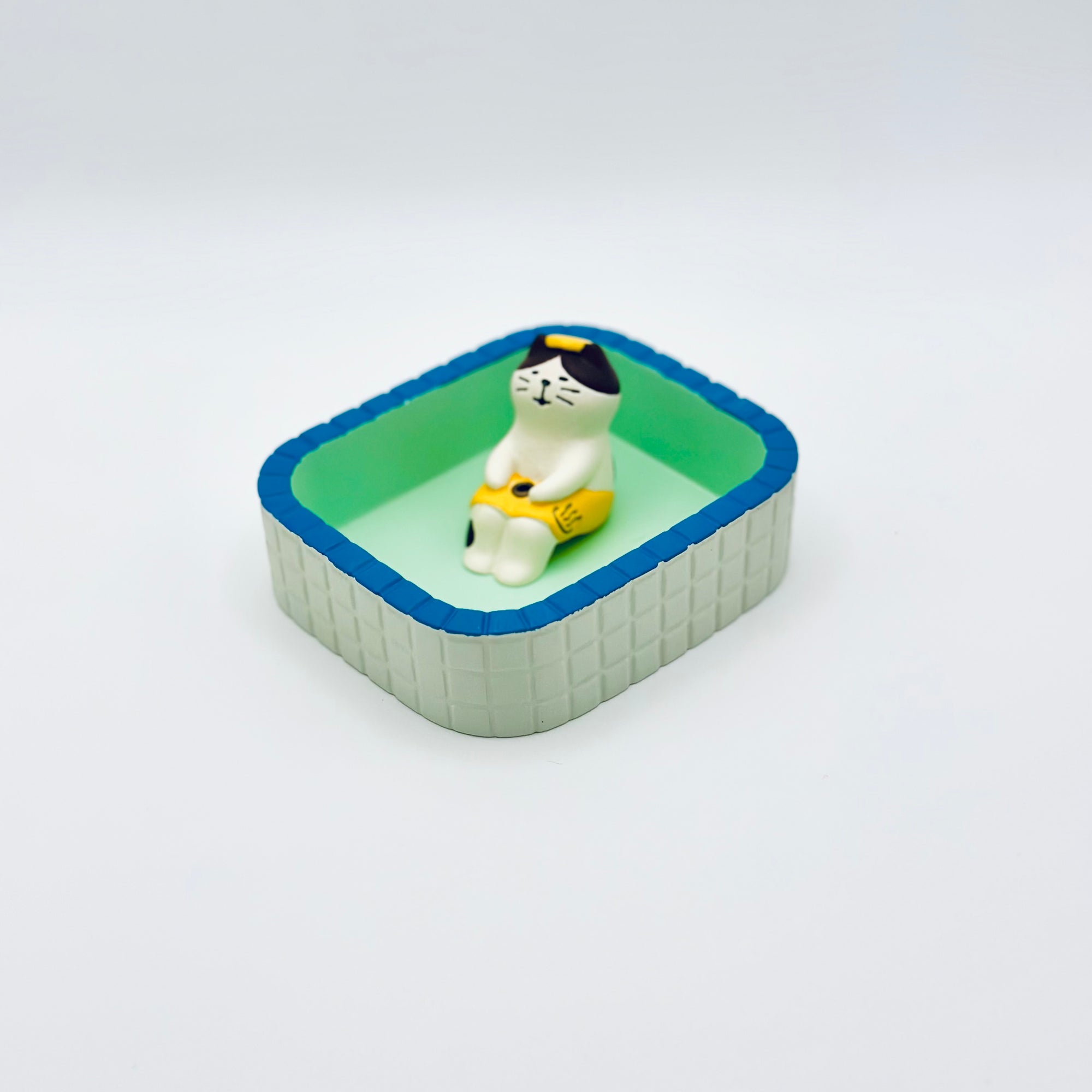 Cat & Towel incense holder placed inside the Purrfect Ash Tub, displayed within the mint-green and blue-rimmed tray.