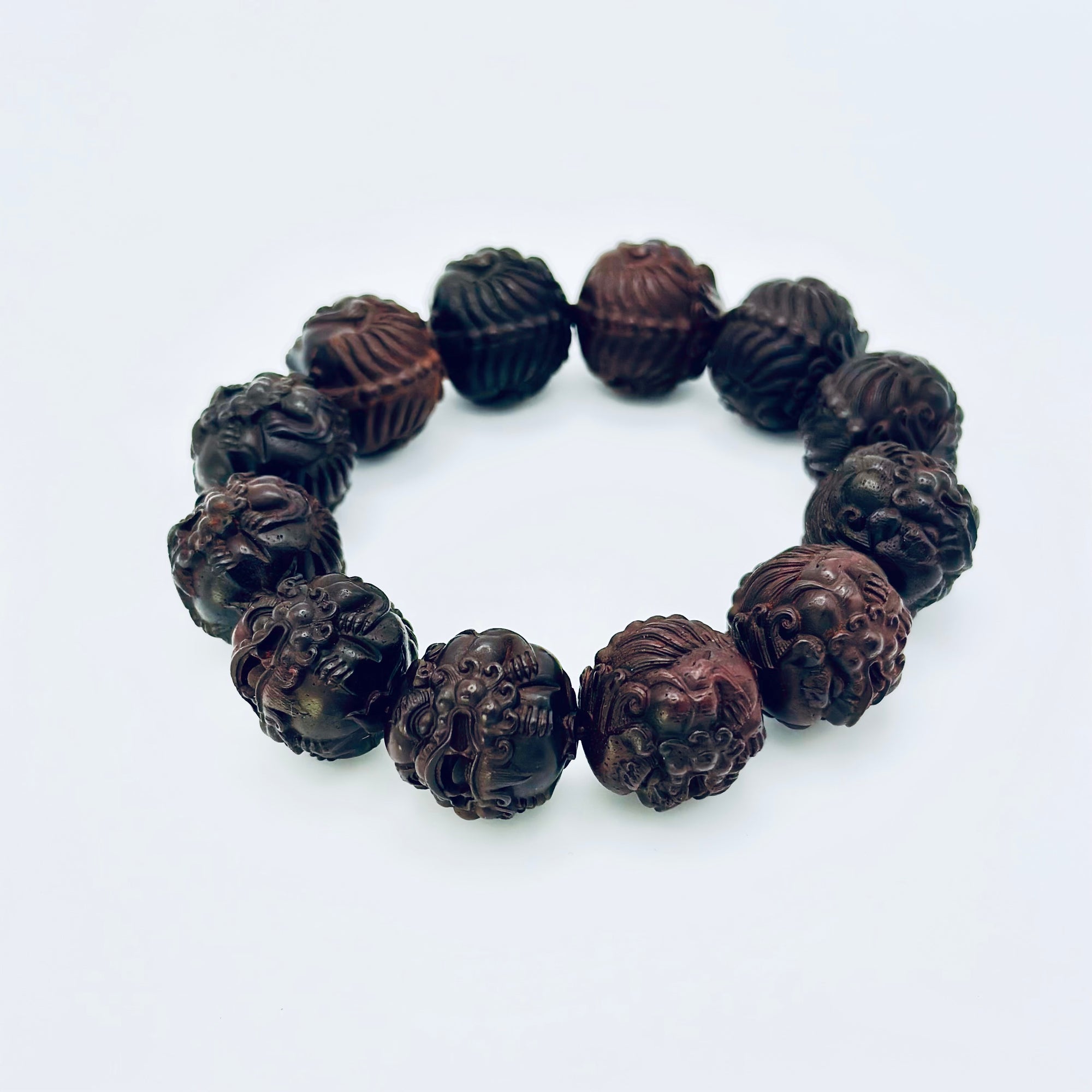 Limited Sacred Edition Guardian Bead Bracelet shown in a full circular layout; individually carved natural wooden beads featuring guardian motifs.