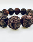 Close-up of the Limited Sacred Edition Guardian Bead Bracelet highlighting the detailed guardian-face carvings on each hand-crafted wooden bead.