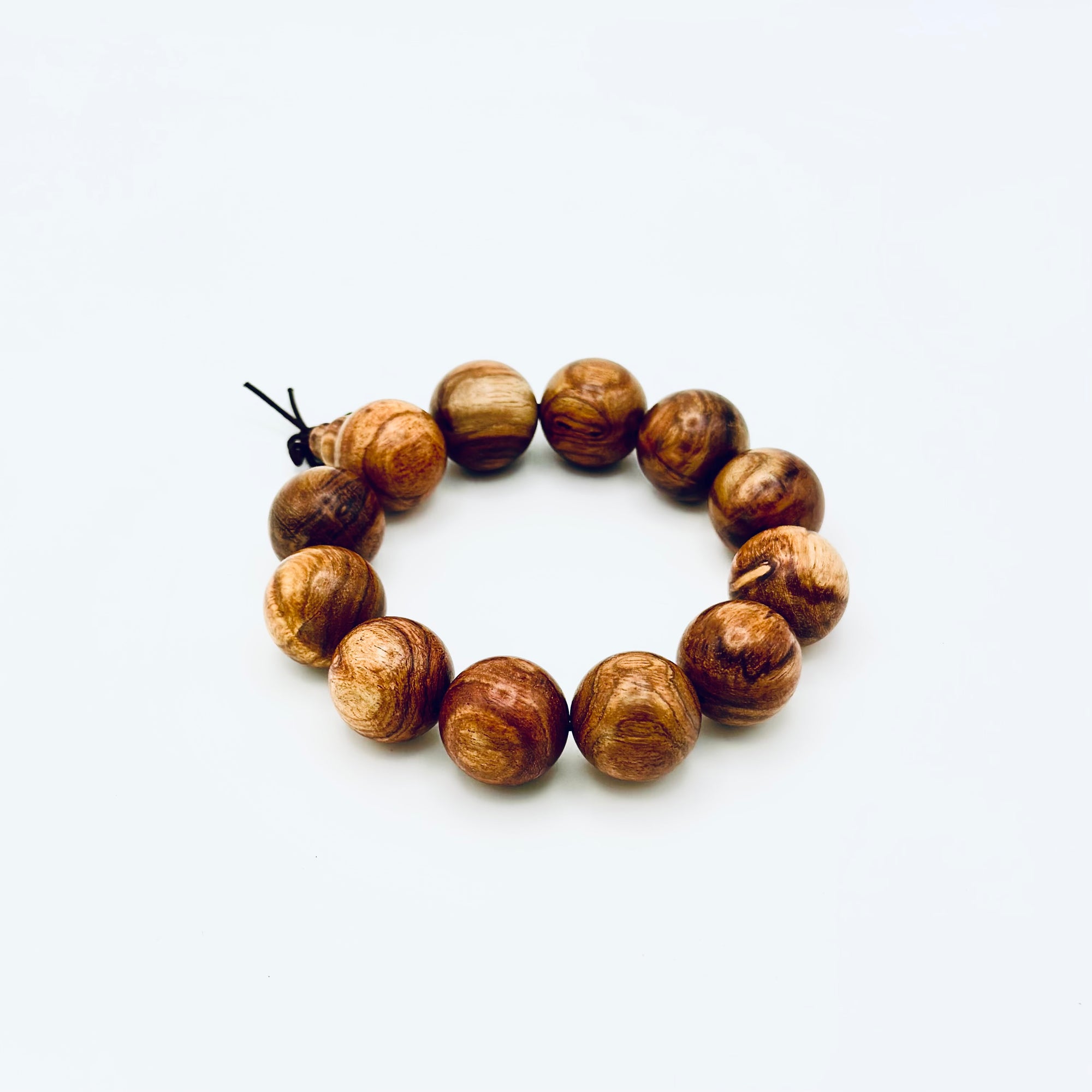 Huanghuali Bead Bracelet (large) crafted from natural rosewood-like hardwood, featuring smooth round beads with rich swirling grain.