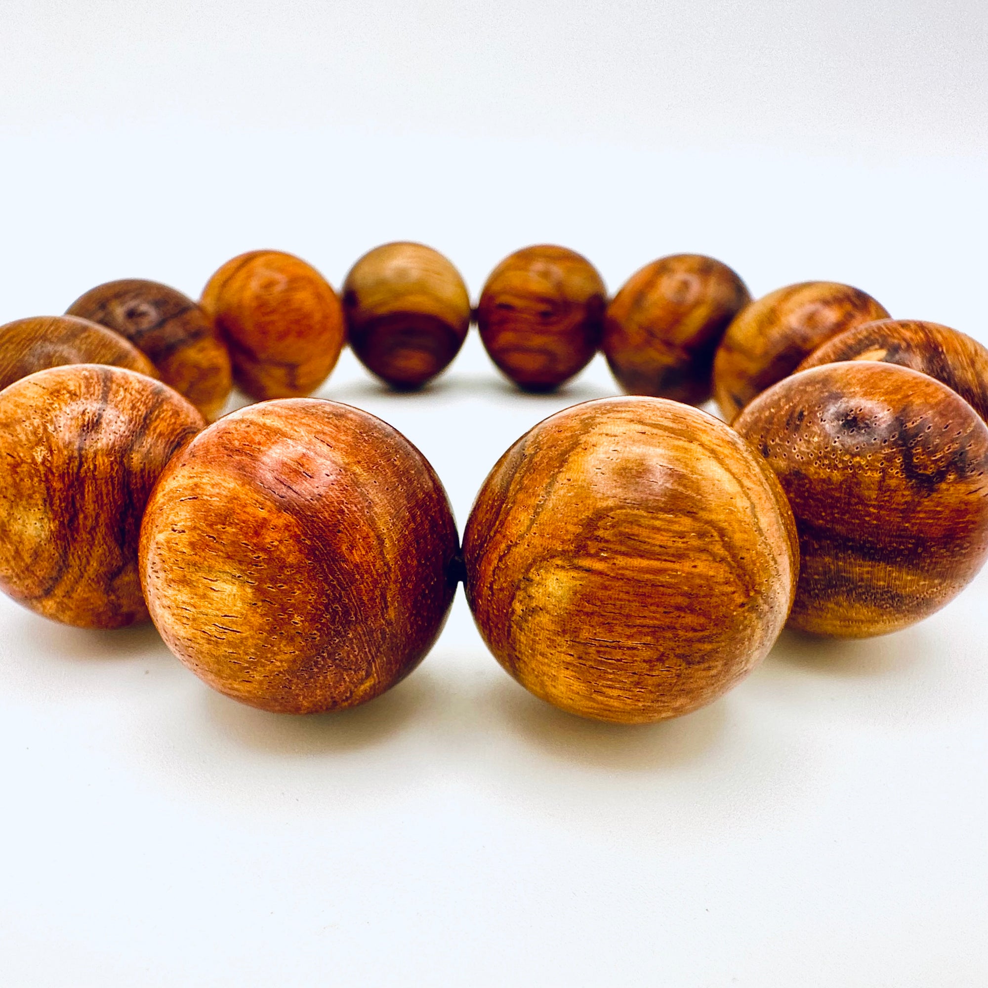 Close-up of Huanghuali Bead Bracelet (large) highlighting the intricate wood grain textures and polished natural finish