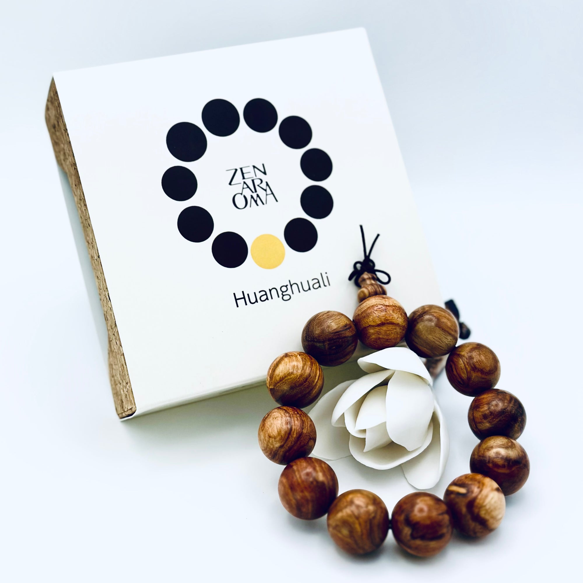 ZA Studio Huanghuali Bead Bracelet (large) displayed with its signature box, showcasing natural grain patterns and warm golden-brown hues.