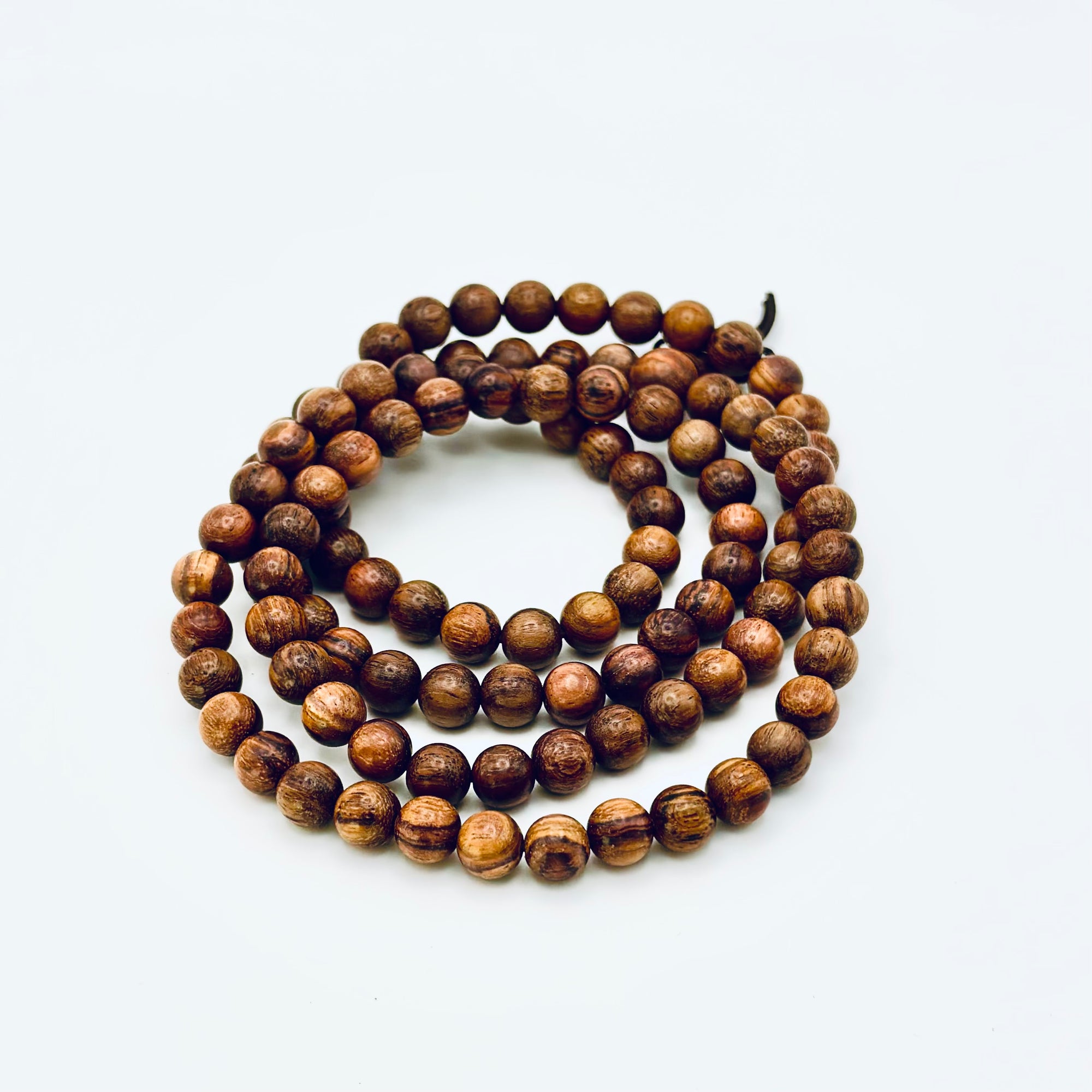 Huanghuali Bead Bracelet (small) crafted from natural rosewood-like hardwood, featuring smooth round beads with rich swirling grain.
