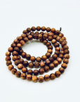 Huanghuali Bead Bracelet (small) crafted from natural rosewood-like hardwood, featuring smooth round beads with rich swirling grain.