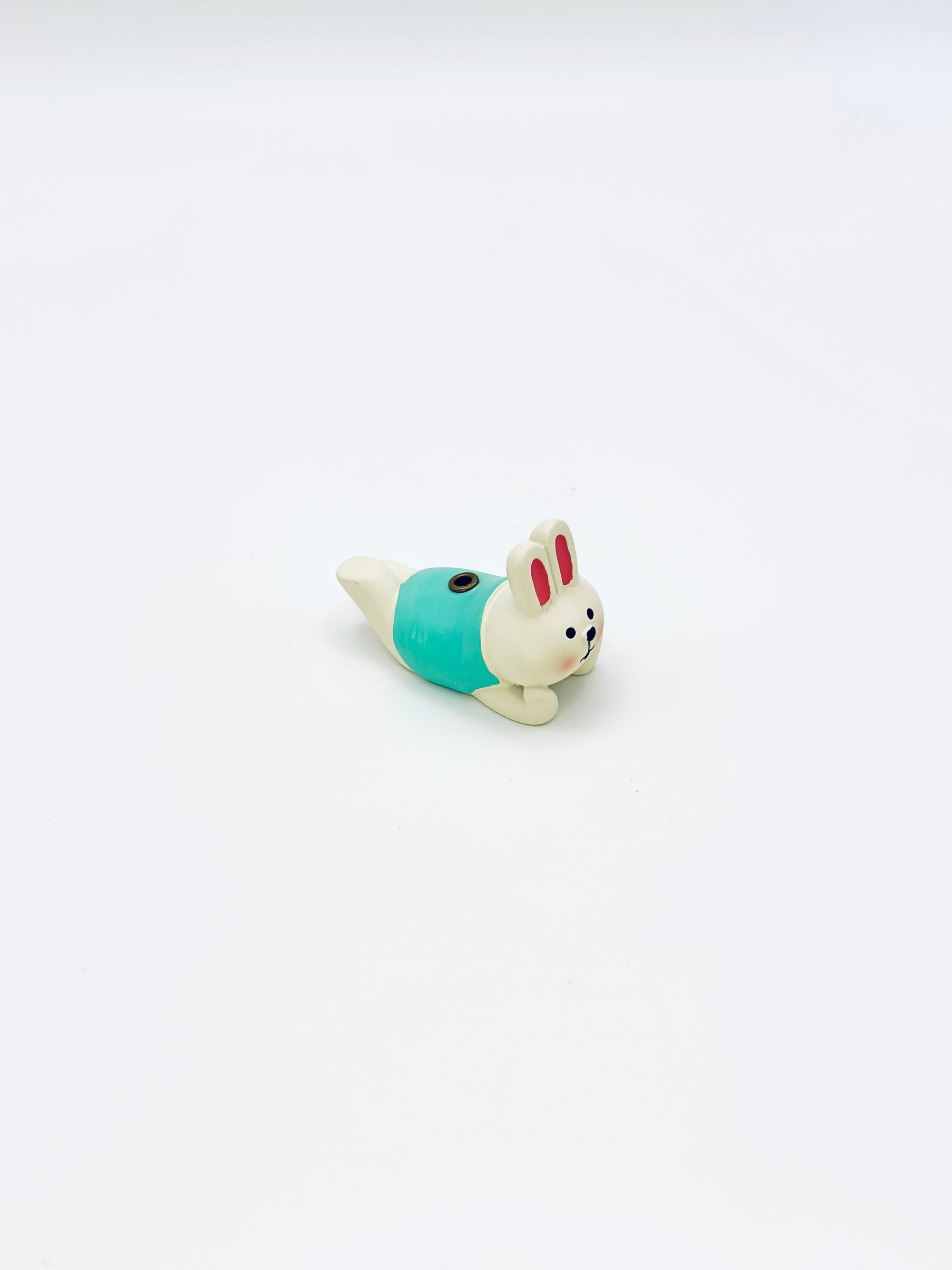 Top-view of the Laying Bunny incense holder, showing the hand-painted details and incense slot on its back.