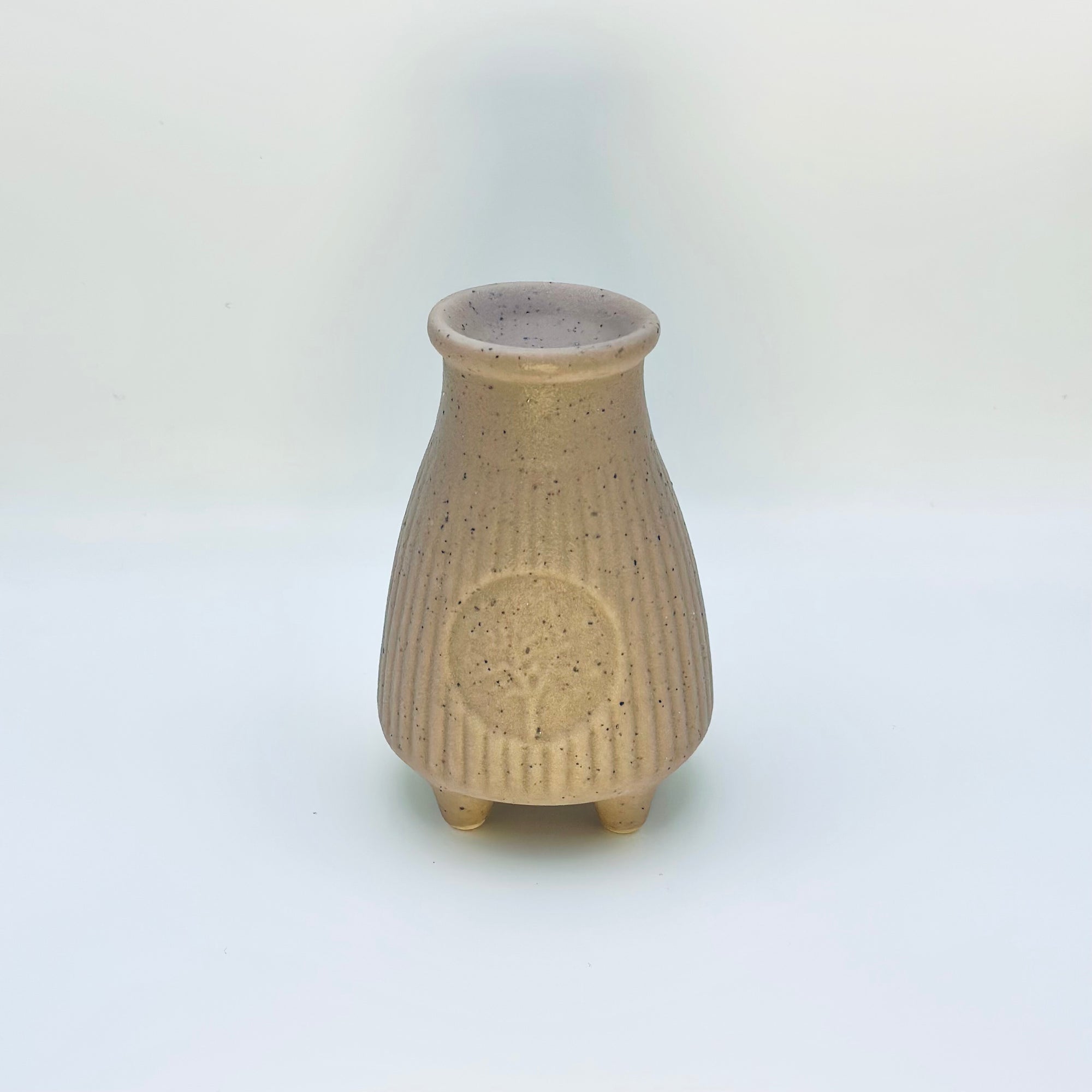 Back view of the Zen Glow Aroma Burner highlighting its textured ceramic surface and circular embossed detail.