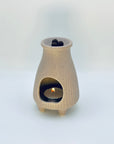 Zen Glow Aroma Burner with tealight glowing inside, gently warming aroma pellets above.