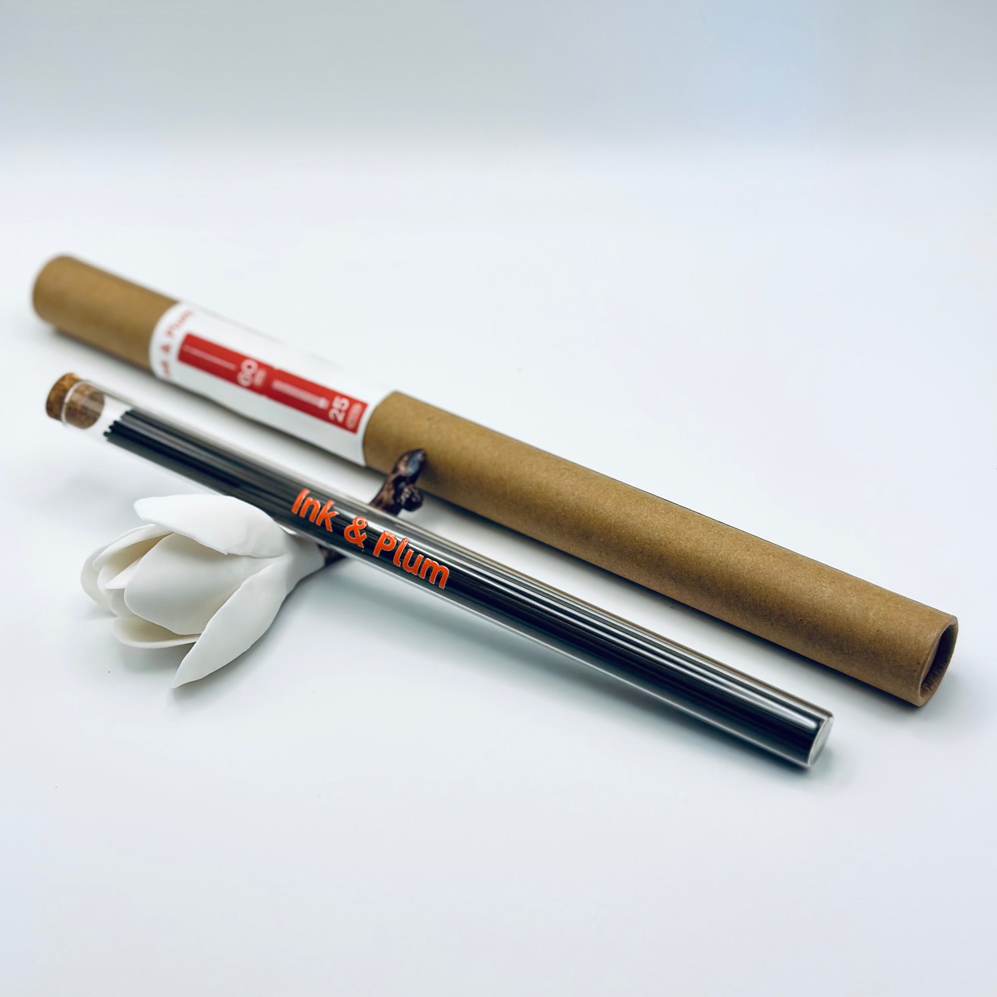 Zen Aroma Ink & Plum incense sticks in a glass tube with cork and brown cardboard tube packaging, displayed on a clean white background.