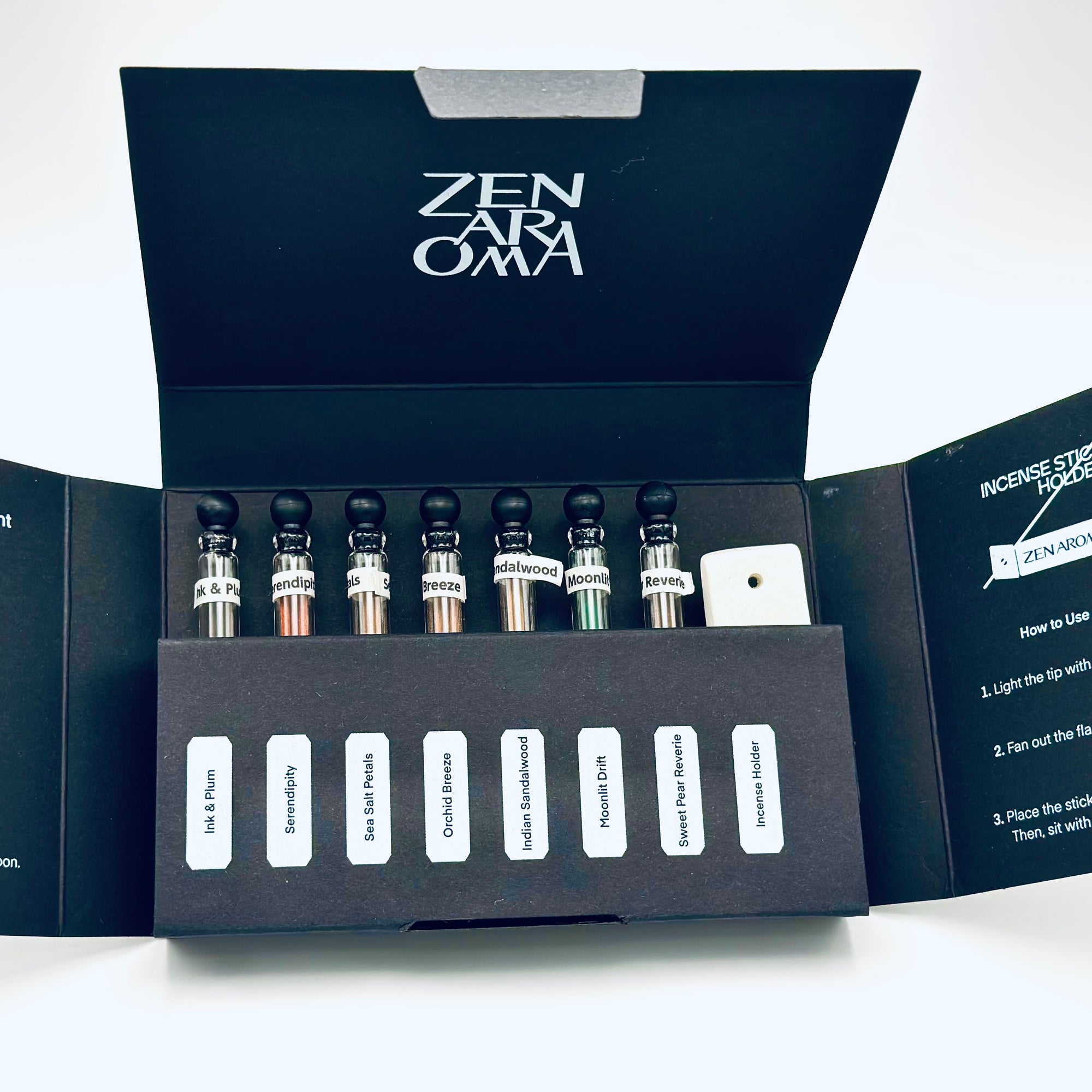 Zen Aroma “Midnight Sampler” open box displaying seven short incense glass vials and a minimalist incense holder, arranged neatly inside black packaging on a white background.