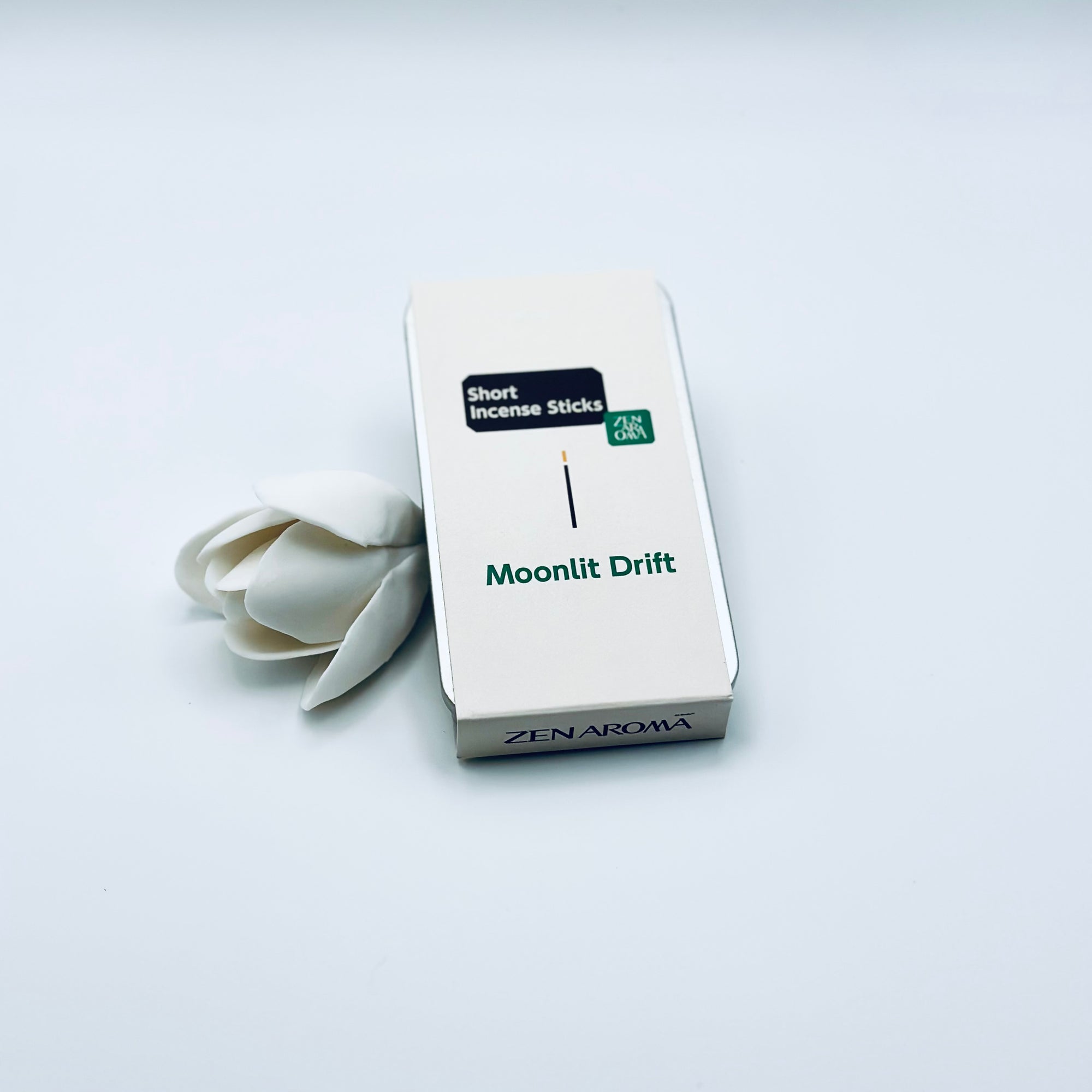 Zen Aroma Moonlit Drift To-Go Incense Kit in beige metal box, styled with a white flower on a clean white background, showcasing minimalist packaging design.
