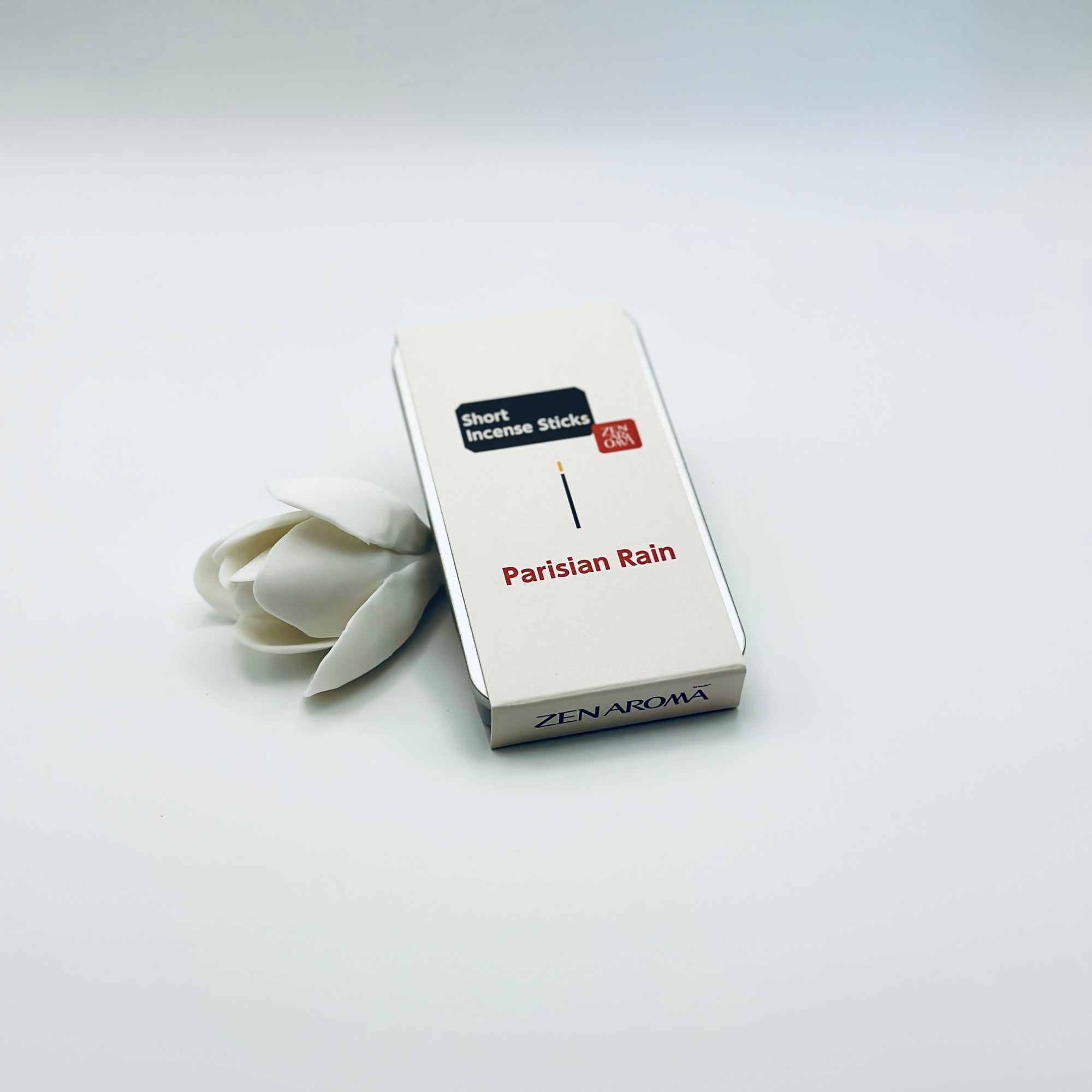 Zen Aroma Parisian Rain To-Go Incense Kit in beige metal box, styled with a white flower on a clean white background, showcasing minimalist packaging design.