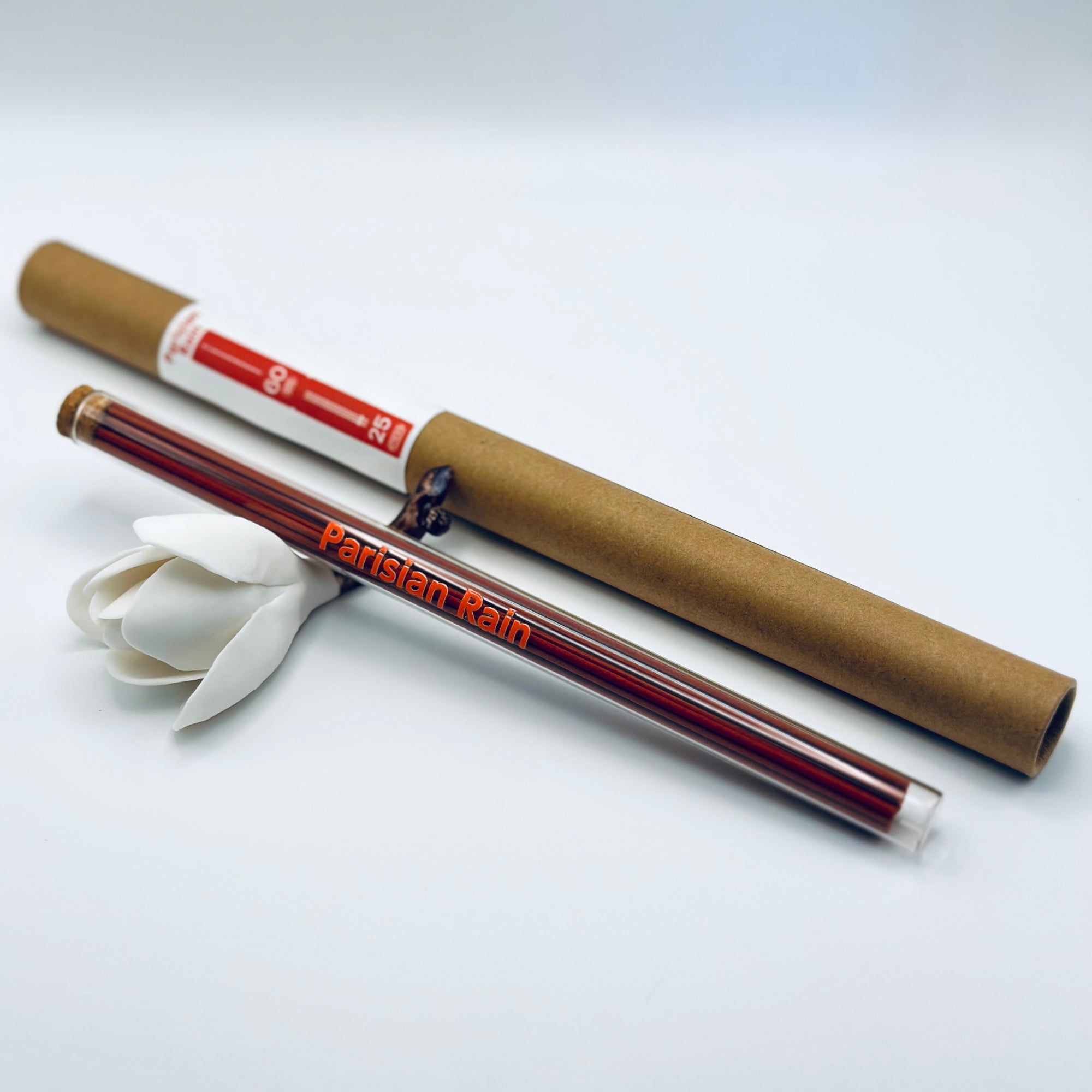 Zen Aroma Parisian Rain incense sticks in a glass tube with cork and brown cardboard tube packaging, displayed on a clean white background.