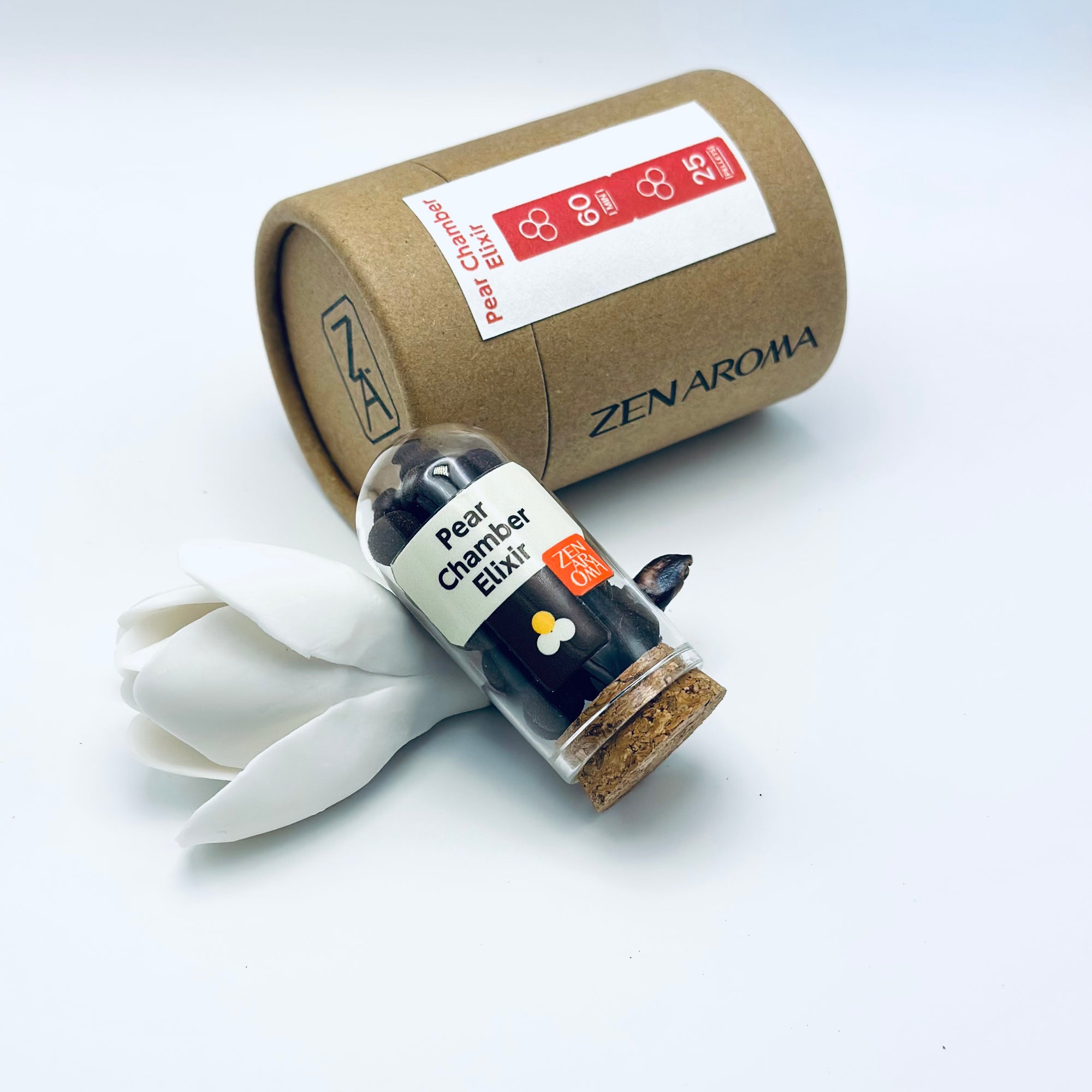 Zen Aroma Pear Chamber Elixir aroma pellets in a glass jar with cork lid, displayed with a kraft paper tube and white flower petals on a light background.