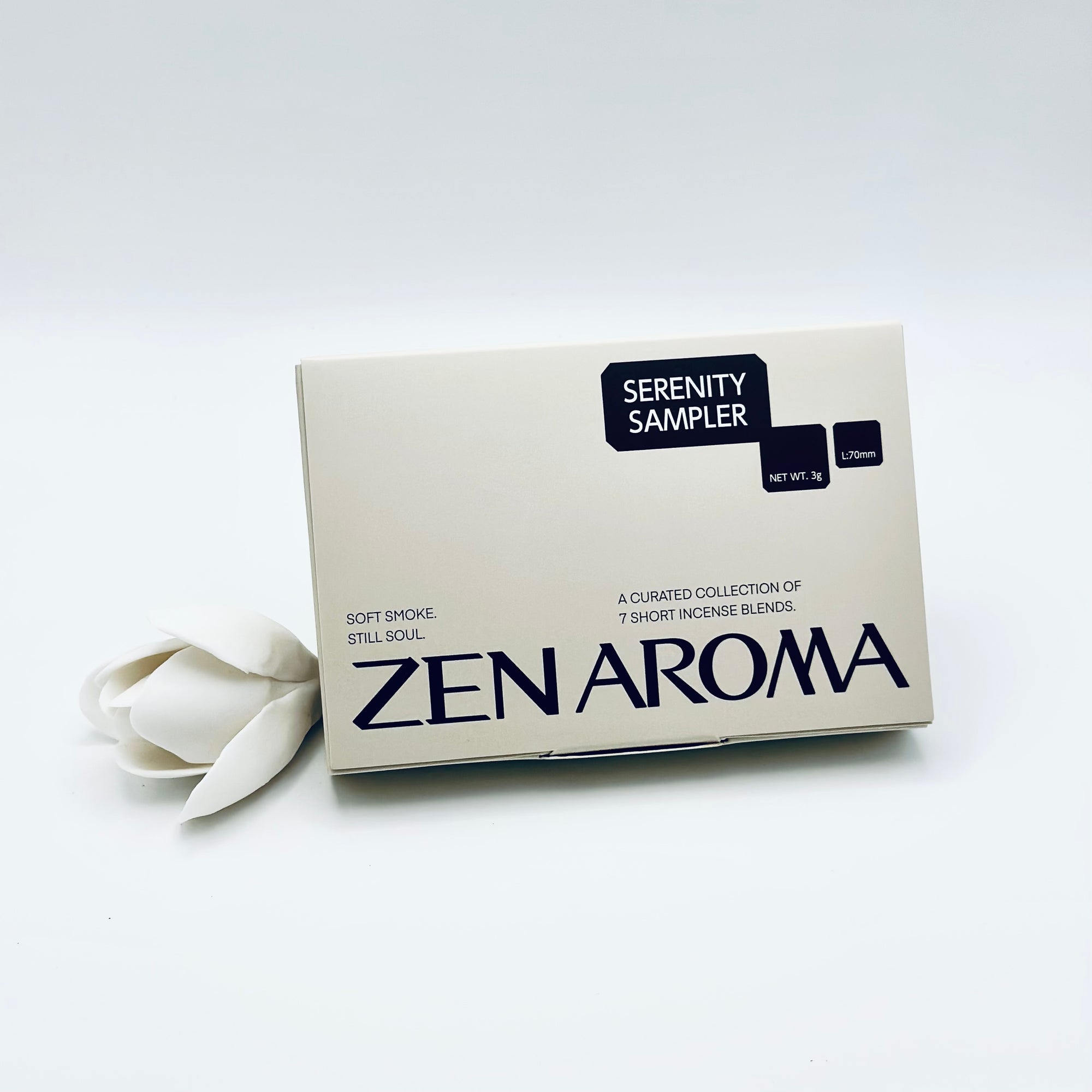 Zen Aroma “Serenity Sampler” box featuring a curated collection of seven short incense blends, styled with a white flower on a soft white background to evoke calm and tranquility.