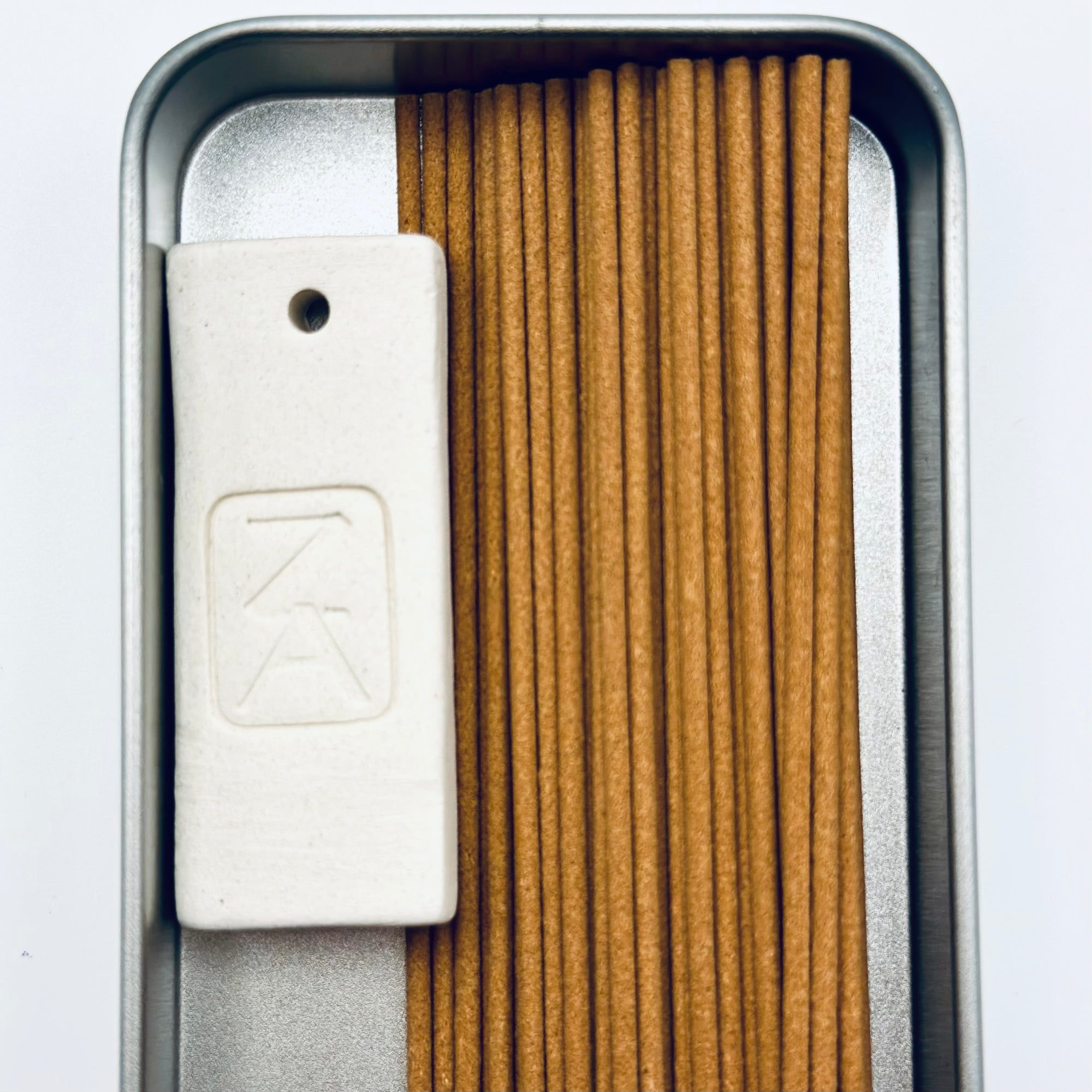 Zen Aroma To-Go Incense Kit featuring handcrafted incense sticks and a minimalist ZA logo incense holder in a metallic travel box.