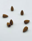 Zen Aroma backflow incense cones arranged on a light background, showcasing natural texture and handcrafted detail.
